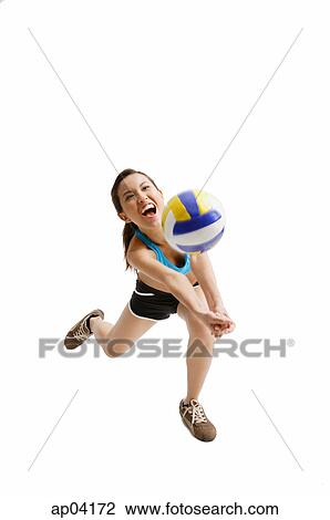 Stock Image - Young woman hitting volleyball . Fotosearch