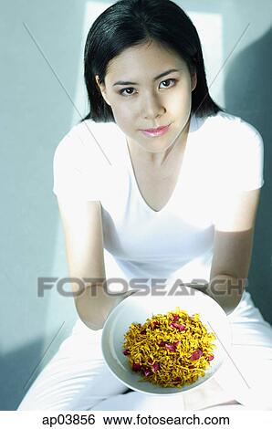 Young woman holding bowl of spices, looking at camera View Large Photo Image Stock Photograph - Young woman holding bowl of spices, looking at camera. Fotosearch