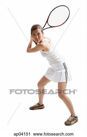 Stock Image - Young woman holding tennis racket, waiting for ball . Fotosearch
