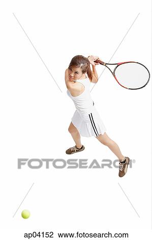 Stock Image - Young woman holding tennis racket, waiting for ball . Fotosearch
