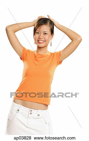 Young woman in orange T shirt looking at camera View Large Photo Image Stock Photo - Young woman in orange T shirt looking at camera. Fotosearch