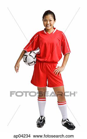 Young woman in soccer uniform, carrying soccer ball under arm View Large Photo Image Picture - Young woman in soccer uniform, carrying soccer ball under arm. Fotosearch