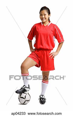 Young woman in soccer uniform, standing with foot on ball and hands on hips View Large Photo Image Stock Image - Young woman in soccer uniform, standing with foot on ball and hands on hips. Fotosearch