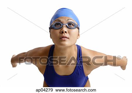 Young woman in swimwear arms stretched behind her, preparing to dive View Large Photo Image Stock Photo - Young woman in swimwear arms stretched behind her, preparing to dive. Fotosearch