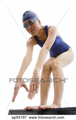 Young woman in swimwear, preparing to jump into water View Large Photo Image Stock Photo - Young woman in swimwear, preparing to jump into water. Fotosearch
