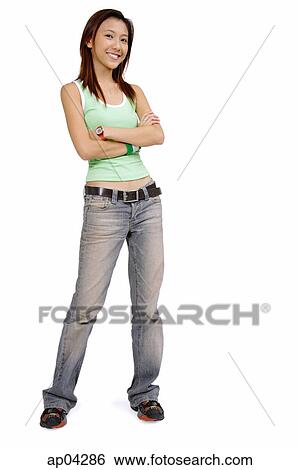 Young woman in tank top and jeans, arms crossed, smiling at camera View Large Photo Image Stock Photograph - Young woman in tank top and jeans, arms crossed, smiling at camera. Fotosearch