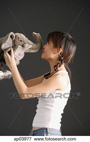 Young woman kissing stuffed toy elephant View Large Photo Image Stock Photo - Young woman kissing stuffed toy elephant. Fotosearch
