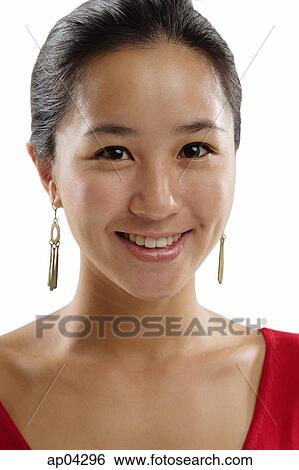 Stock Photograph - Young woman looking at camera, head shot . Fotosearch