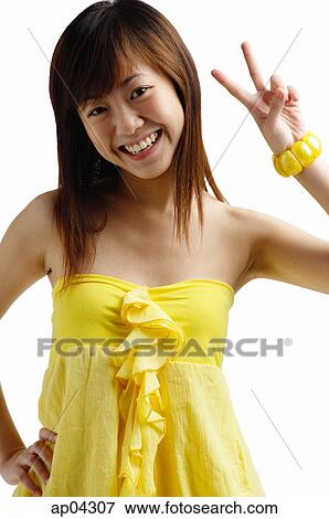 Young woman looking at camera, making hand sign View Large Photo Image Stock Photo - Young woman looking at camera, making hand sign. Fotosearch