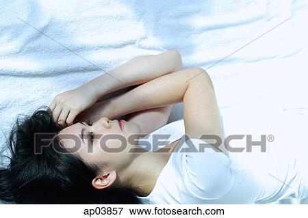 Stock Photo - Young woman lying on side. Fotosearch