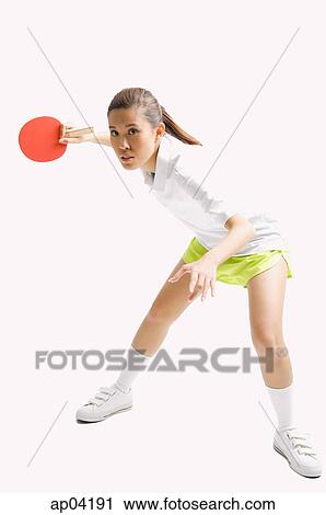 Young woman playing table tennis, studio shot View Large Photo Image Stock Image - Young woman playing table tennis, studio shot . Fotosearch