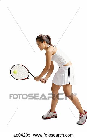Young woman playing tennis, studio shot View Large Photo Image Stock Photography - Young woman playing tennis, studio shot . Fotosearch