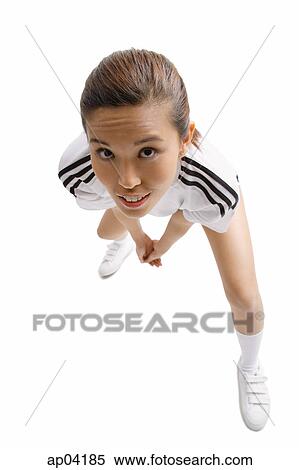 Young woman standing, looking up at camera, hands clasped View Large Photo Image Stock Photography - Young woman standing, looking up at camera, hands clasped. Fotosearch