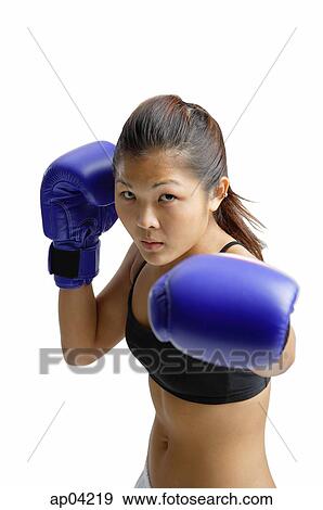 Stock Photo - Young woman wearing boxing gloves. Fotosearch