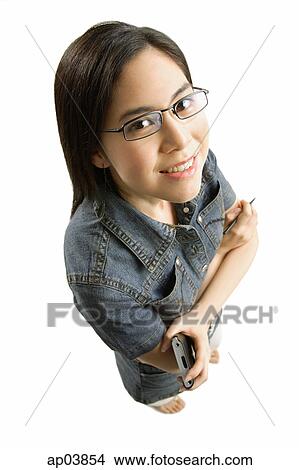 Young woman with glasses, arms crossed, smiling at camera View Large Photo Image Picture - Young woman with glasses, arms crossed, smiling at camera. Fotosearch