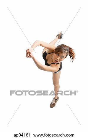 Young woman with hands clasped, jumping to hit ball View Large Photo Image Stock Image - Young woman with hands clasped, jumping to hit ball. Fotosearch