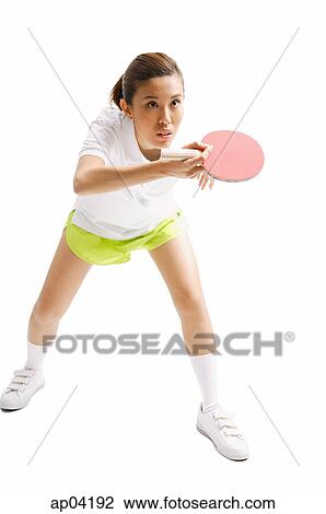 Stock Image - Young woman with table tennis racket, studio shot . Fotosearch
