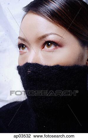 Young woman with turtleneck pulled up over half of face, looking away View Large Photo Image Stock Image - Young woman with turtleneck pulled up over half of face, looking away . Fotosearch