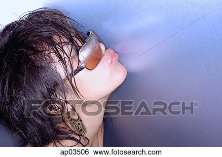 Young woman with wet hair and sunglasses, kissing wall View Large Photo Image Stock Photograph - Young woman with wet hair and sunglasses, kissing wall. Fotosearch
