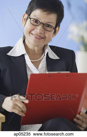 Business woman holding clipboard View Large Photo Image Stock Photography - Business woman holding clipboard. Fotosearch