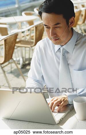 Businessman in cafe with laptop View Large Photo Image Stock Photography - Businessman in cafe with laptop. Fotosearch