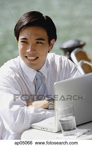 Stock Photograph - Businessman sitting at outdoor cafe. Fotosearch