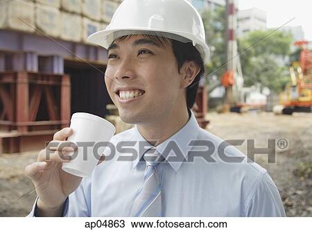 Businessman wearing hardhat, drinking from disposable cup View Large Photo Image Stock Image - Businessman wearing hardhat, drinking from disposable cup. Fotosearch