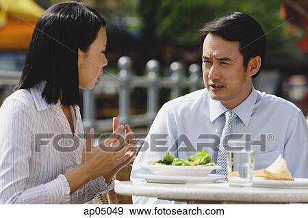 Businesswoman and businessman at outdoor cafe, having lunch, talking View Large Photo Image Stock Photo - Businesswoman and businessman at outdoor cafe, having lunch, talking. Fotosearch