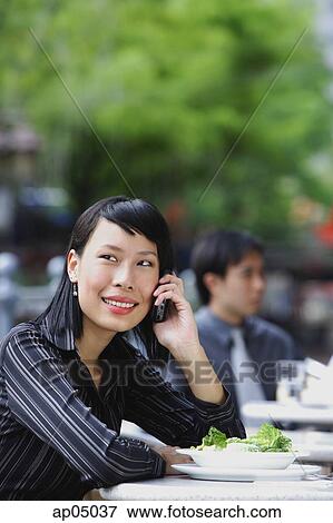 Businesswoman at outdoor cafe, using mobile phone View Large Photo Image Stock Photo - Businesswoman at outdoor cafe, using mobile phone. Fotosearch