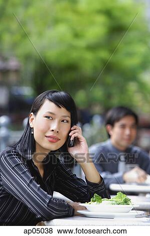 Businesswoman using mobile phone at outdoor cafe View Large Photo Image Stock Photo - Businesswoman using mobile phone at outdoor cafe. Fotosearch