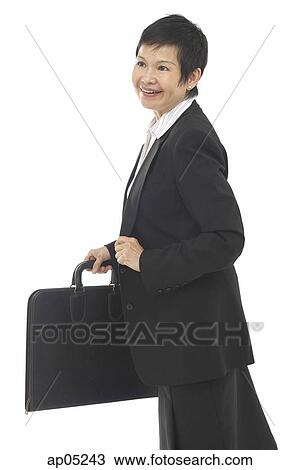 Businesswoman with briefcase, looking away, smiling View Large Photo Image Stock Image - Businesswoman with briefcase, looking away, smiling. Fotosearch