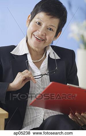 Businesswoman with clipboard, portrait View Large Photo Image Stock Photo - Businesswoman with clipboard, portrait. Fotosearch