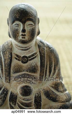 Close-up of small Buddha sculpture View Large Photo Image Stock Image - Close-up of small Buddha sculpture. Fotosearch