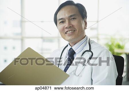 Doctor smiling at camera View Large Photo Image Stock Image - Doctor smiling at camera. Fotosearch