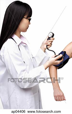 Female doctor checking blood pressure of patient View Large Photo Image Stock Photograph - Female doctor checking blood pressure of patient. Fotosearch