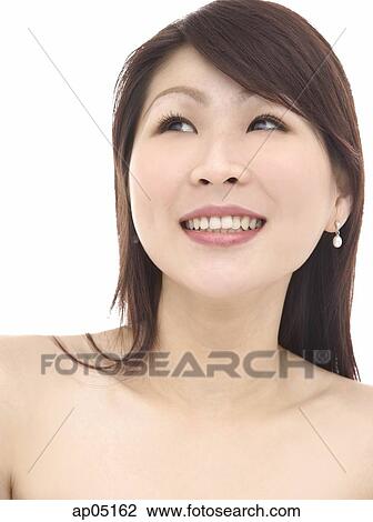Stock Image - Head shot of woman, smiling, looking away. Fotosearch