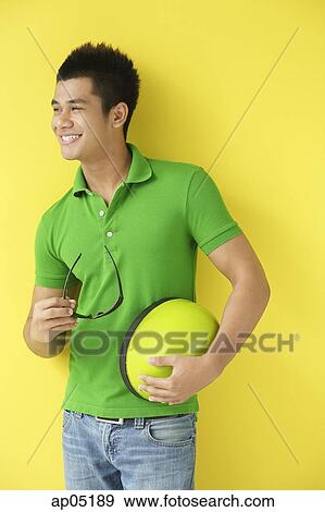 Man carrying helmet, looking away View Large Photo Image Stock Photo - Man carrying helmet, looking away. Fotosearch