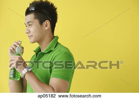 Stock Image - Man drinking from water from bottle. Fotosearch