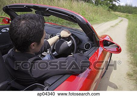 Man driving red convertible sports car View Large Photo Image Stock Image - Man driving red convertible sports car. Fotosearch