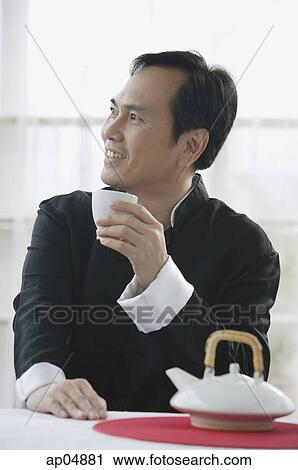 Man having some Chinese tea, looking away View Large Photo Image Stock Image - Man having some Chinese tea, looking away. Fotosearch