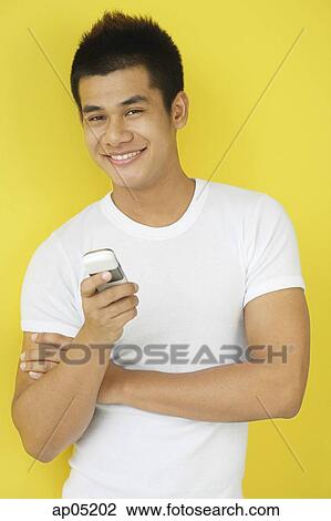 Man holding mobile phone View Large Photo Image Stock Image - Man holding mobile phone. Fotosearch