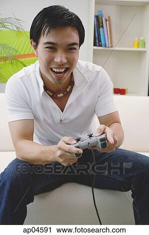 Man holding video game controller View Large Photo Image Stock Image - Man holding video game controller. Fotosearch