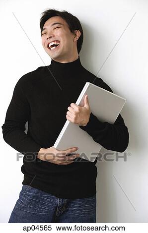 Man hugging laptop, laughing View Large Photo Image Stock Photography - Man hugging laptop, laughing. Fotosearch