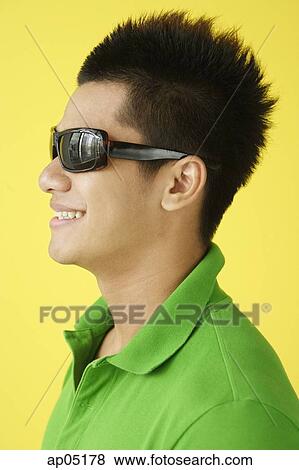 Man in green polo shirt and sunglasses, side view, head shot View Large Photo Image Stock Photo - Man in green polo shirt and sunglasses, side view, head shot. Fotosearch