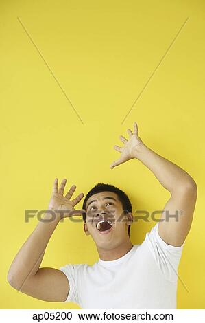 Man looking up, mouth open and hands raised View Large Photo Image Stock Image - Man looking up, mouth open and hands raised. Fotosearch