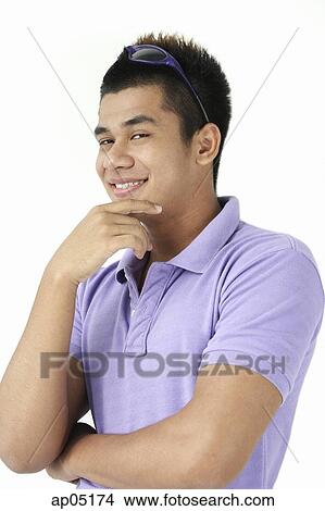 Picture - Man smiling, hand on chin. Fotosearch