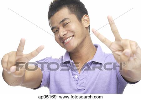 Man smiling, making peace hand sign View Large Photo Image Stock Photo - Man smiling, making peace hand sign. Fotosearch