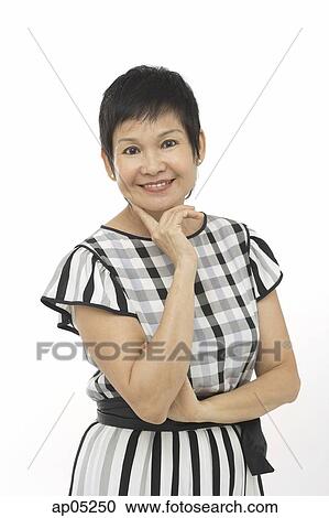 Mature woman against white background, hand on chin, smiling at camera View Large Photo Image Stock Image - Mature woman against white background, hand on chin, smiling at camera. Fotosearch