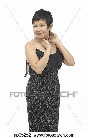 Stock Image - Mature woman in black dress, portrait. Fotosearch