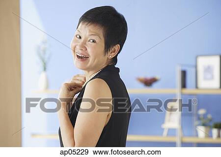 Mature woman smiling at camera View Large Photo Image Stock Photo - Mature woman smiling at camera. Fotosearch